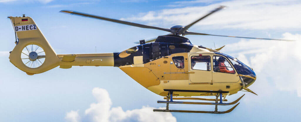 Airbus H135 helicopter in flight.