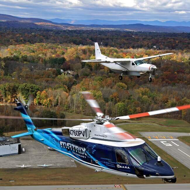 DARPA's Aircrew Labor In-Cockpit Automation System (ALIAS) program demonstrates its developmental technology system on a Cessna 208 Caravan fixed-wing aircraft and a Sikorsky S-76 helicopter during Phase 2 flight tests. DARPA Photo