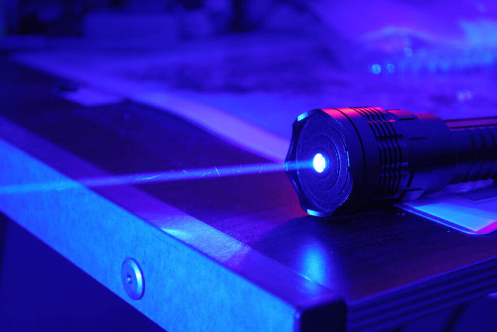 Laser pointer shoots a beam of blue light