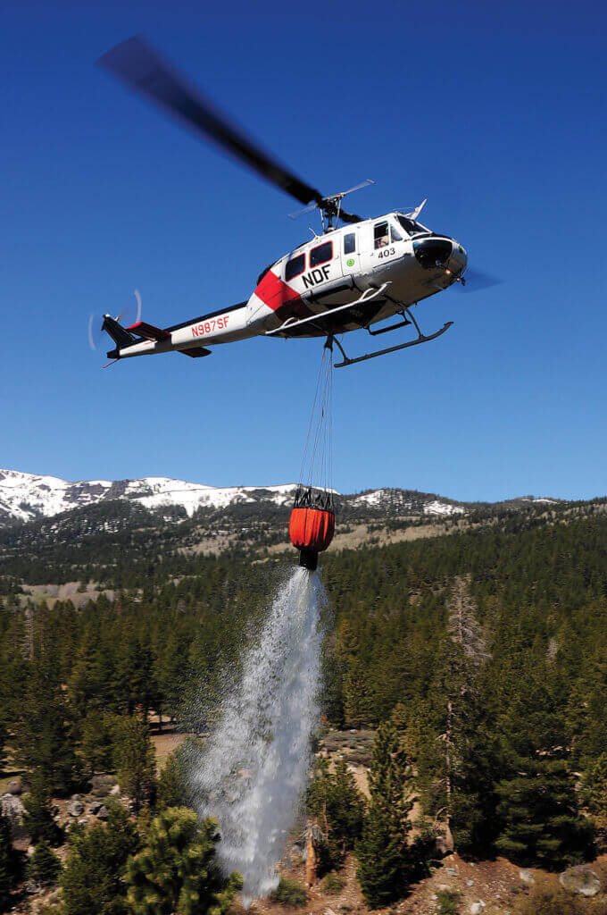 Since this photo was taken, the NDF has upgraded its 240-gallon Bambi Buckets to the more capable PowerFill version that allows the helicopter to use water from many more sources.