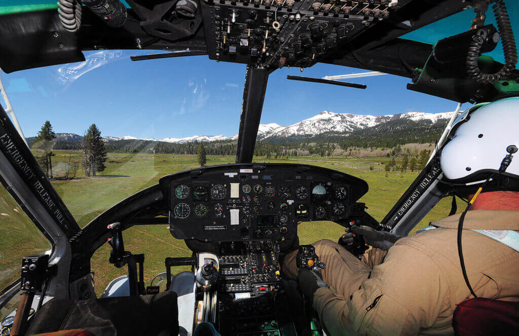 During firefighting operations, the Huey is flown with a single pilot to keep weight as low as possible.