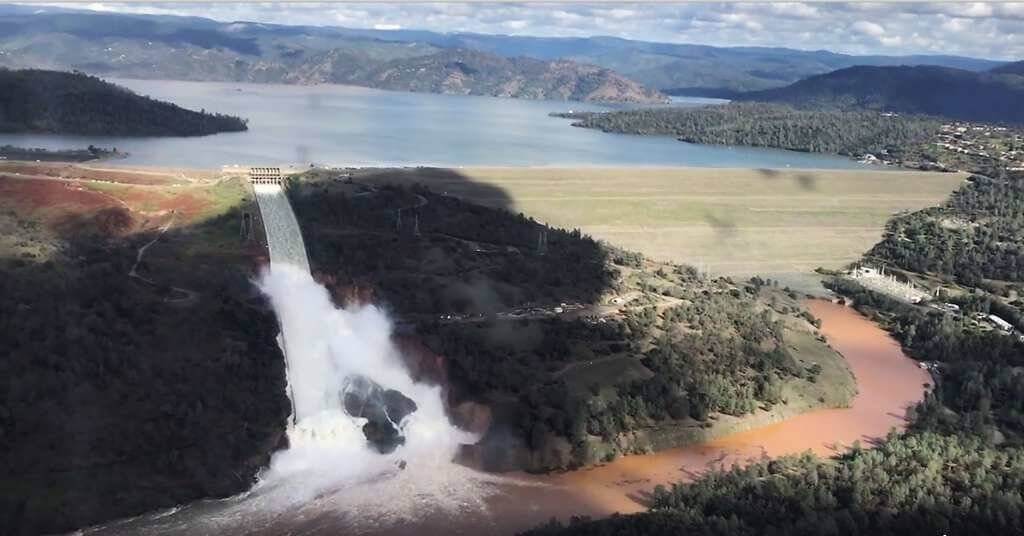 Due to a wetter than average winter, the reservoir has swelled to heights not seen in decades. As a result, the dam's primary spillway has been used heavily to accommodate the excess volume. PJ Helicopters Photo