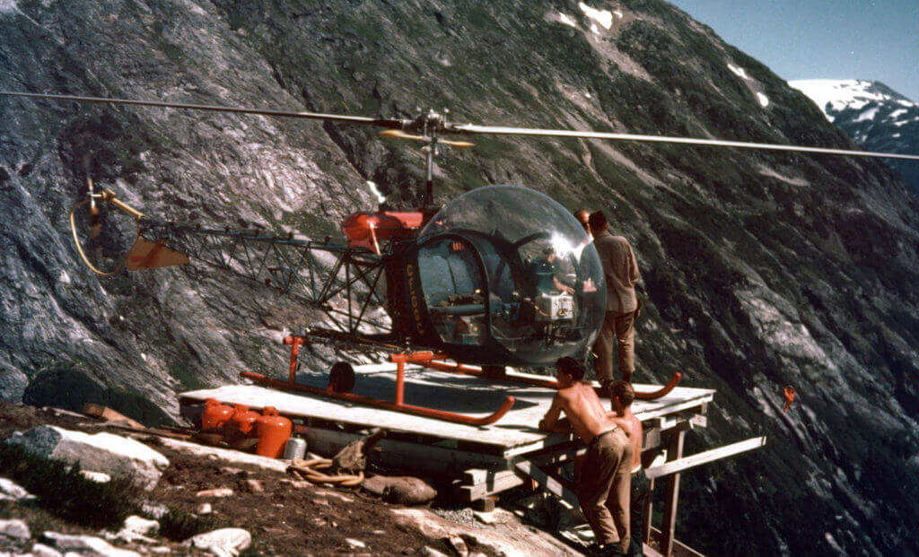 A Bell 47D-1, CF-GGC, high in British Columbia's coastal mountains during the Kemano project in 1953. Purchased by the Aluminum Company of Canada in 1952, the helicopters were crewed and maintained by Okanagan Helicopters. Alcan Photo