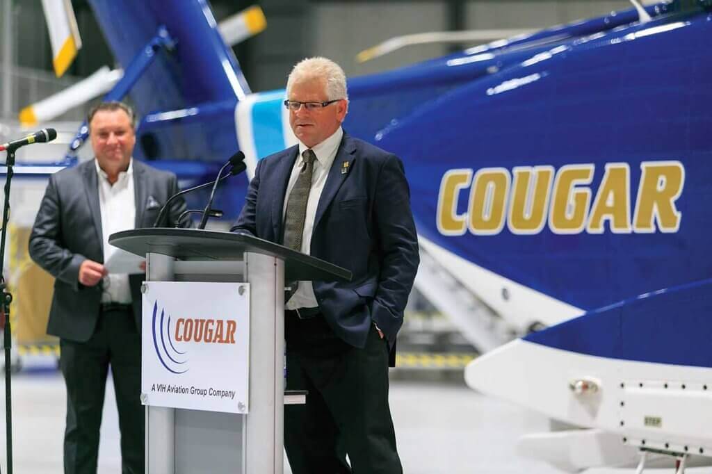 Ken Norie (right), president and CEO of Cougar Helicopters' parent company VIH Aviation Group, was part of the presentation team at the facility's grand opening in November. Cougar COO Hank Williams (left) watches on. Heath Moffatt Photo