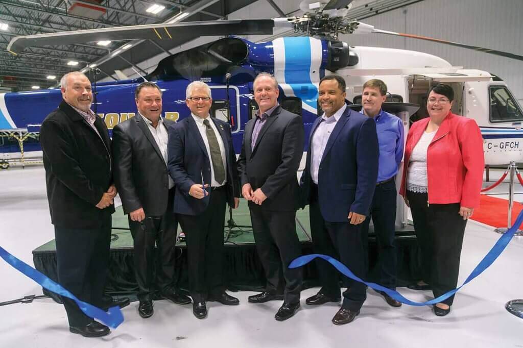 Norie cuts the ribbon to officially open the new hangar, joined by executives from Bristow, oil company customers, and provincial finance minister Cathy Bennett. Heath Moffatt Photo