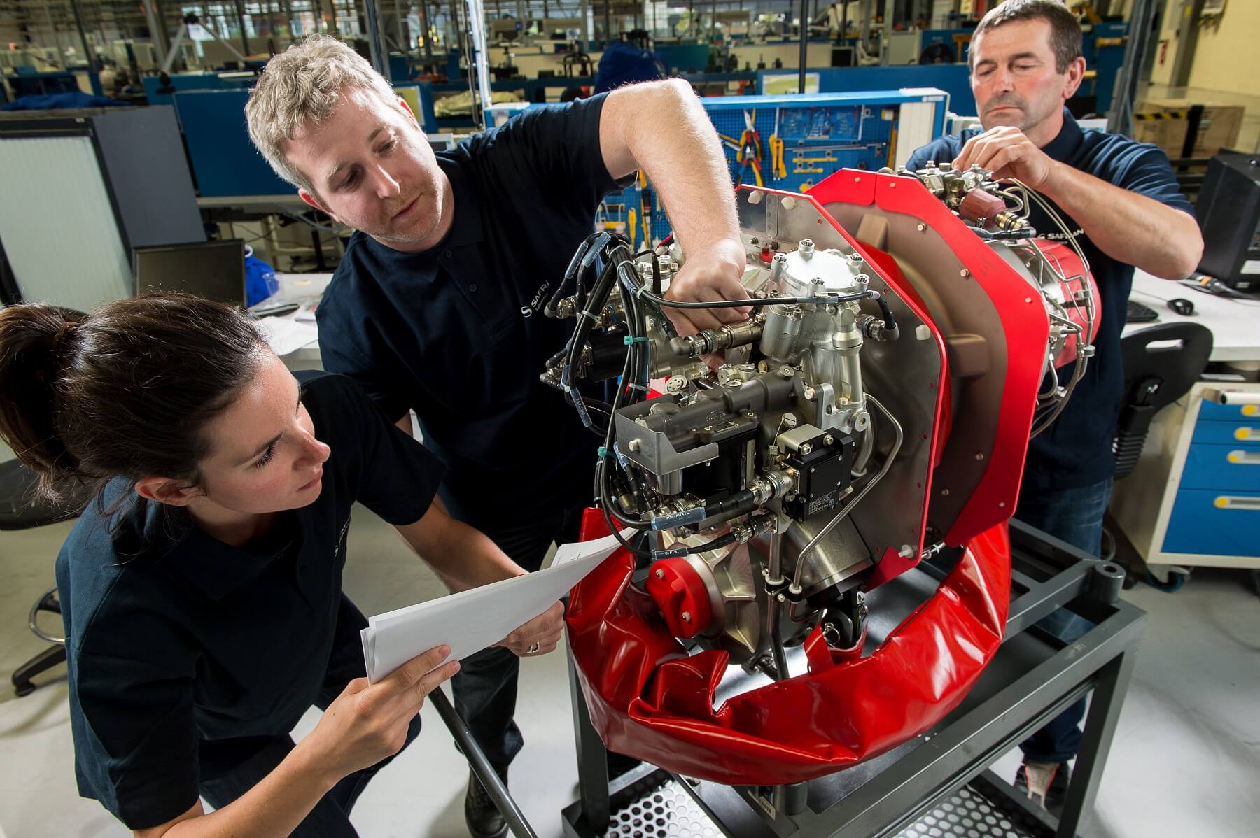 Workers surround a Safran Arrius 2R engine.