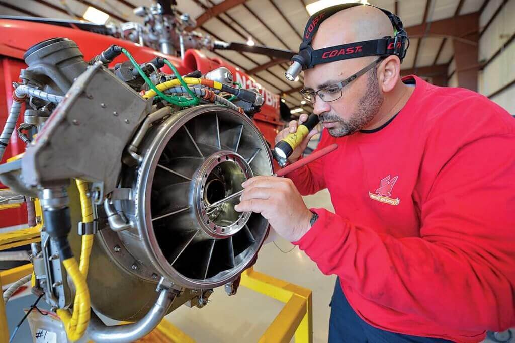 Senior maintenance technician Roberto Velez, here inspecting a GE T700-GE-701C/D engine, is one of Firehawk's longest-tenured employees.