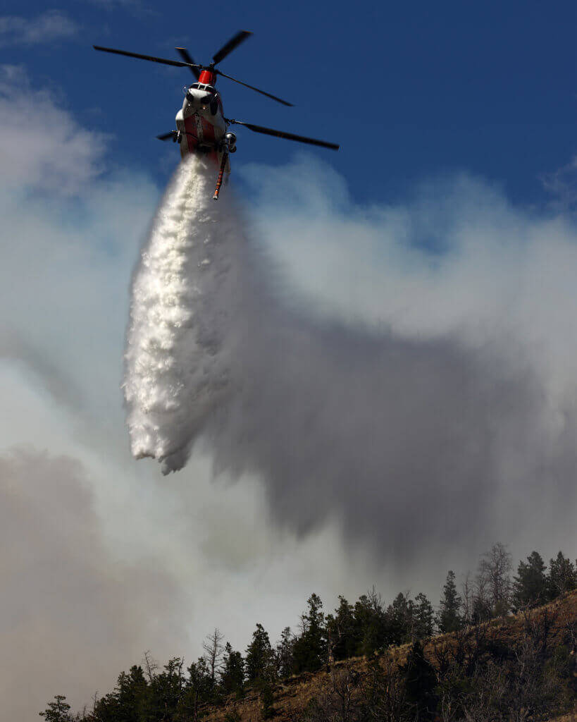 A Boeing CH-47D operated by Columbia Helicopters makes a firefighting water drop.