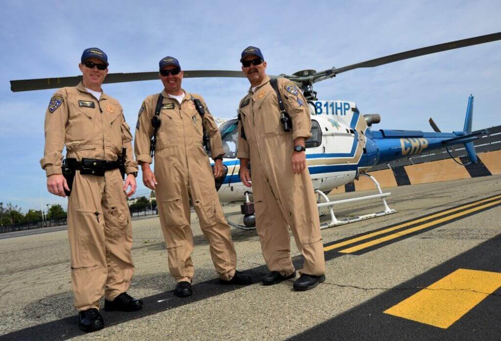 An Apple Valley-based California Highway Patrol crew pose for the camera in front of their Airbus AS350 B3. Skip Robinson Photo