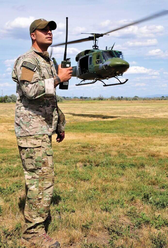 A SERE instructor calls in the UH-1N for a pick-up. The 36th RQS supports the Air Force's Survival School in many ways. Skip Robinson Photos