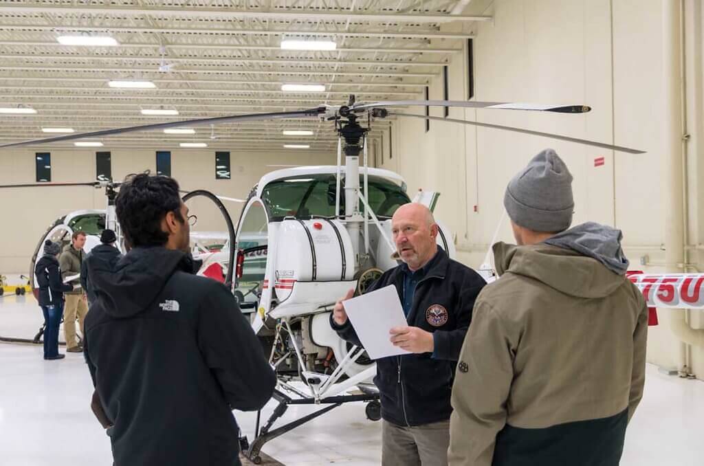 Chief helicopter pilot Ron Depue gives a group briefing on a preflight.