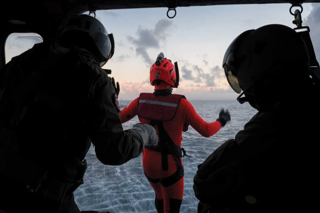 A rescue swimmer leaps from the AW139 into the ocean below during a training exercise.