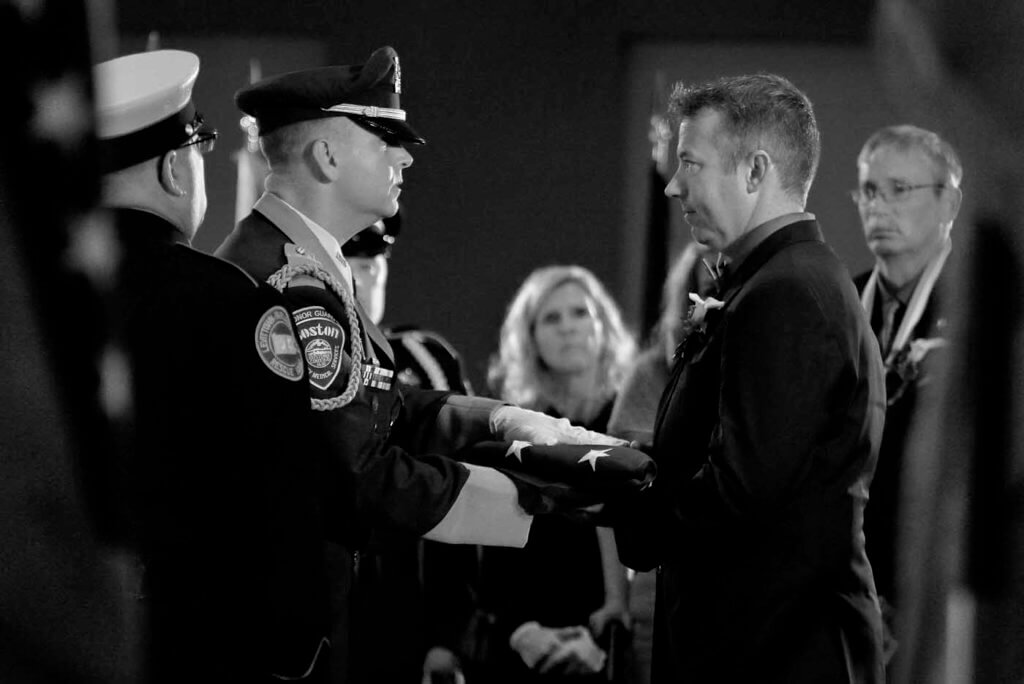 Firefighter Jim Foster accepts the flag for his late fiancée Tiffany Urresti at the National EMS Memorial Service earlier this year. Mark Mennie Photo