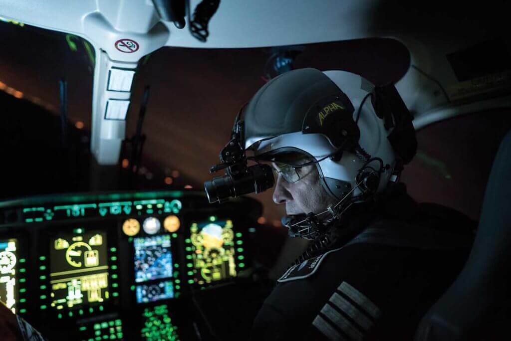 Pilot sits in darkened cockpit.