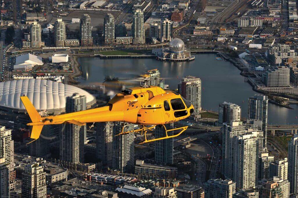 An Airbus AS355 TwinStar, operated by Talon Helicopters, flies over downtown Vancouver, B.C. Talon president Peter Murray said that while Nav Canada does listen to helicopter operator's concerns, the organization is airline-focused. Graham Lavery Photo