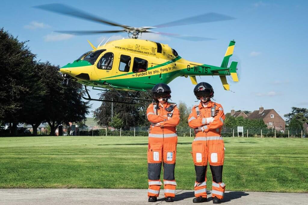 A critical care paramedic and trainee CCP flanked by the charity's Bell 429 at Wiltshire's home base. 