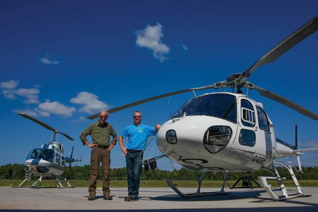 Gord Bain (left), a seasonal pilot with Heli Muskoka, stands alongside McMackin on the flight line. Bain brings huge experience to his role, having flown for more than 30 years with the Ontario Ministry of Natural Resources and Forestry.
