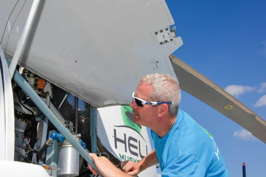 Heli Muskoka's chief pilot/operations manager Jay McMackin takes a look under the cowling.