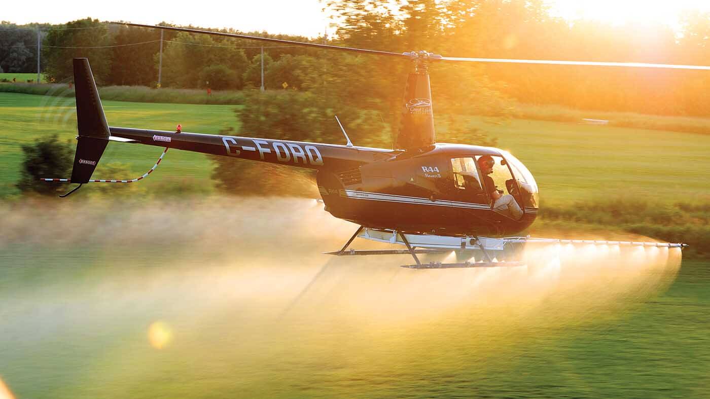 A Robinson R44 Raven II belonging to Great Lakes Helicopter of Kitchener, Ontario, completes spray work in the area. Mike Reyno Photo