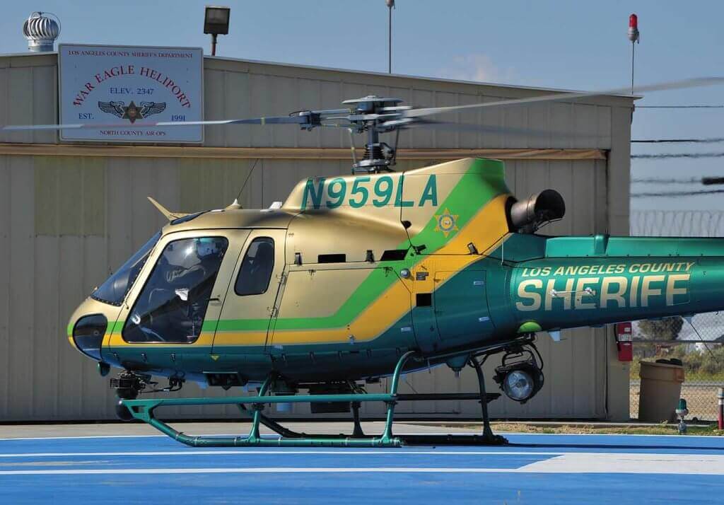 Helicopter rests on helipad.