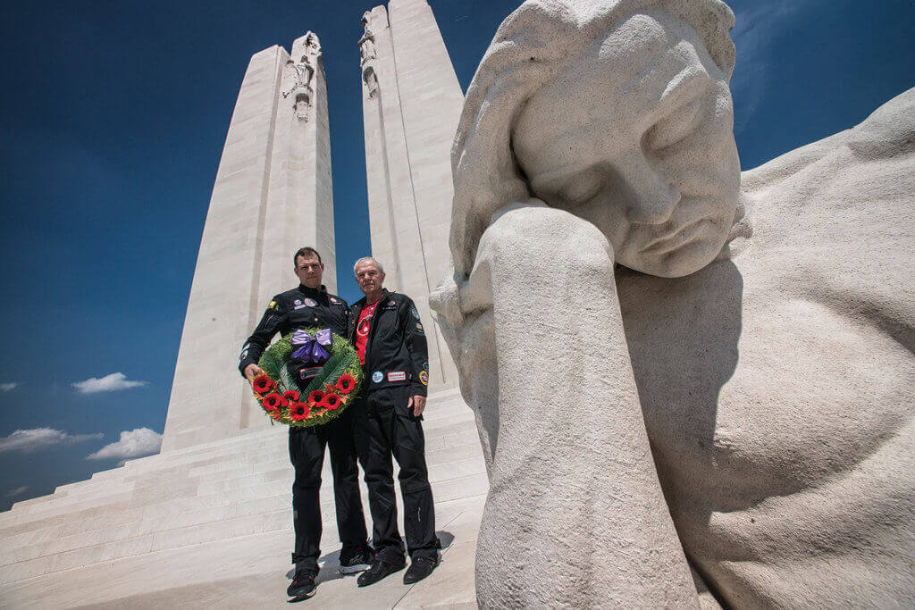Steven Dengler, left, and his father Bob carry a wreath at the Canadian National Vimy Memorial in France in the summer of 2017.