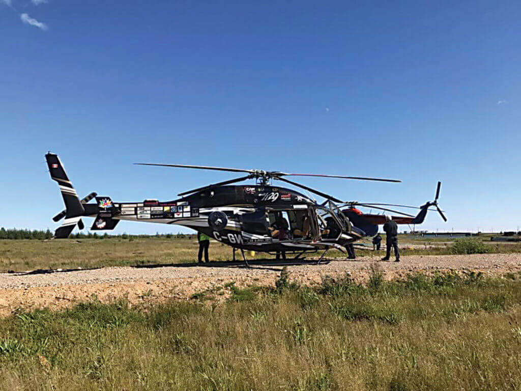 Helicopter rests on a gravel strip in Magadan, Russia.