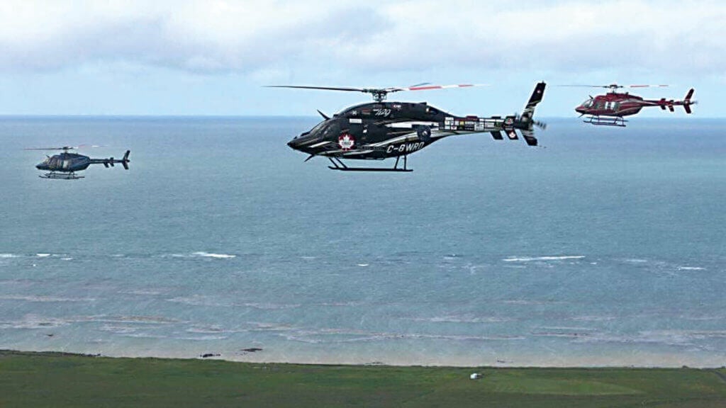 Bob Dengler's Bell 429 (centre) flies in formation over Iceland.