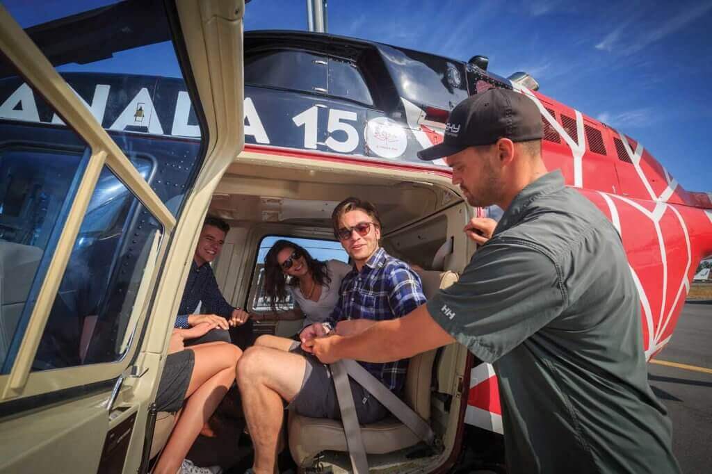 A group of tour passengers is strapped in to the back of the LongRanger. Sky Helicopter offers a range of tour packages suiting a wide range of customer budgets. Heath Moffatt Photo