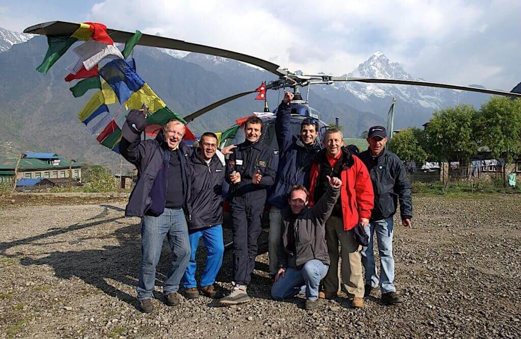 Airbus Helicopter team stands in front of helicopter in Nepal