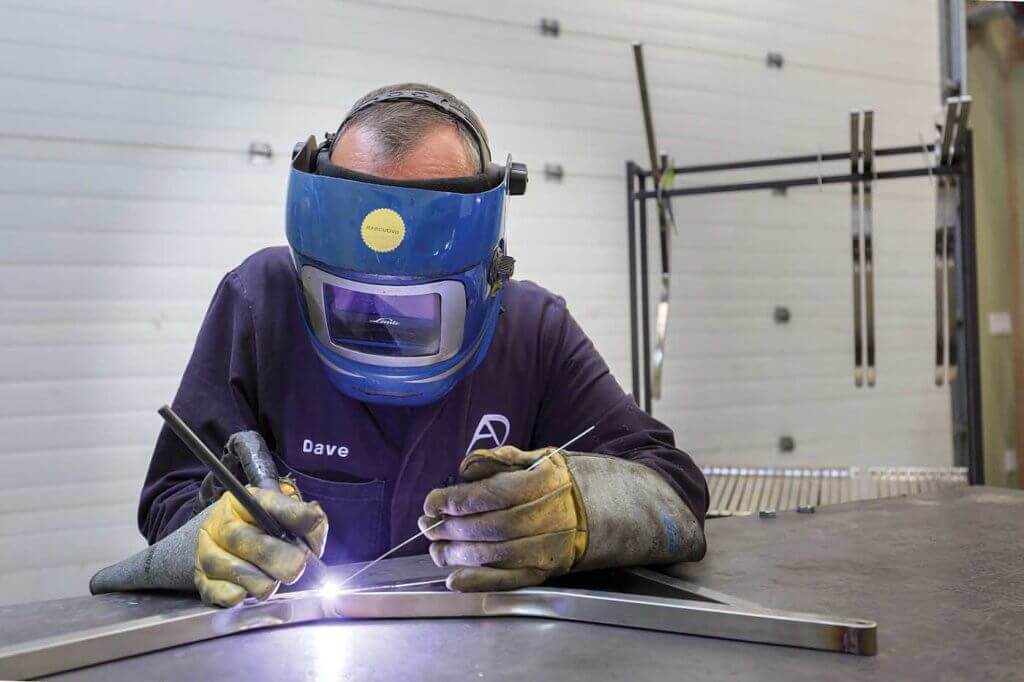 Man welding in shop.