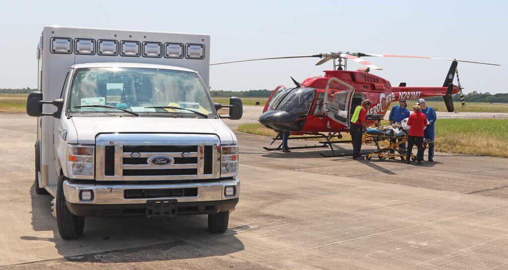 An AeroCare Bell 407 performs a patient transfer at a staging area in Houston. Chris Ebdon Photo
