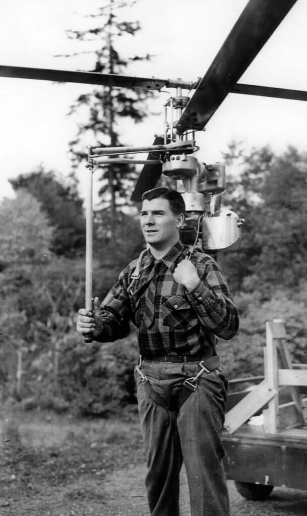 A front view on PEntecost Hoppi-Copter HX-1 backpack helicopter on a pilot's shoulders. Jeff Evans Collection Photo