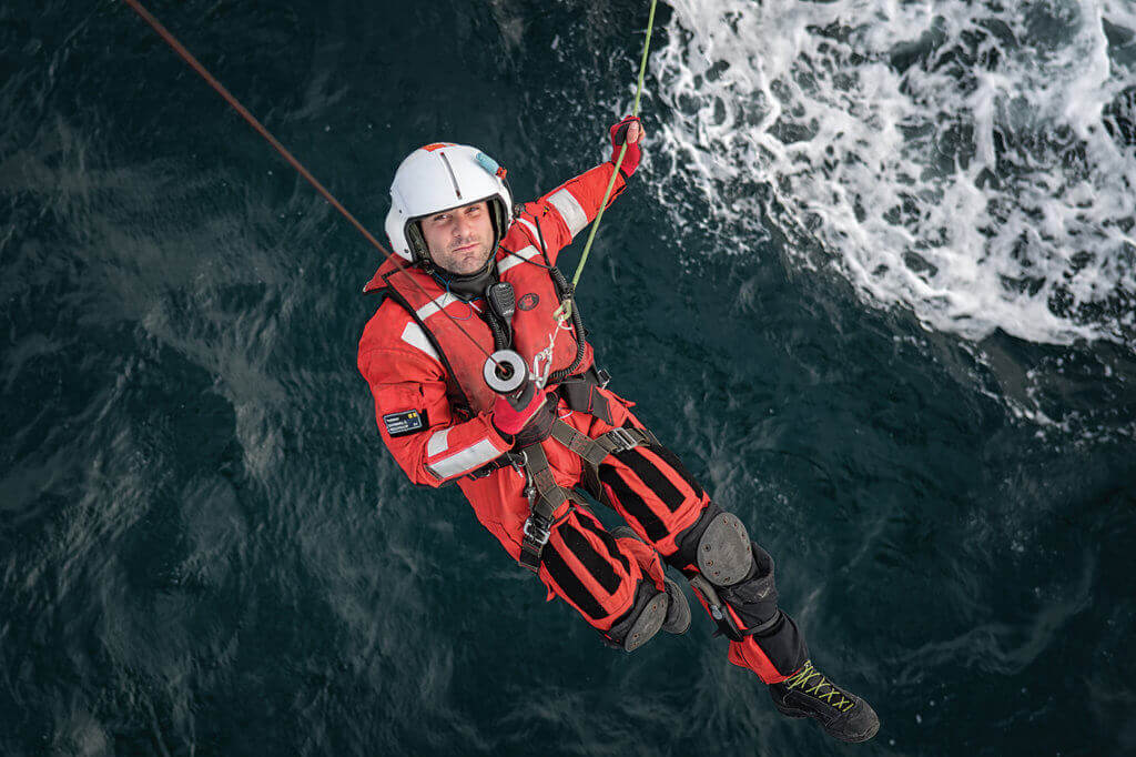 Rescue swimmer Ruben Santamaria is winched back up to the AW139 from a shipping vessel. Lloyd Horgan, Vortex Aeromedia Photo 