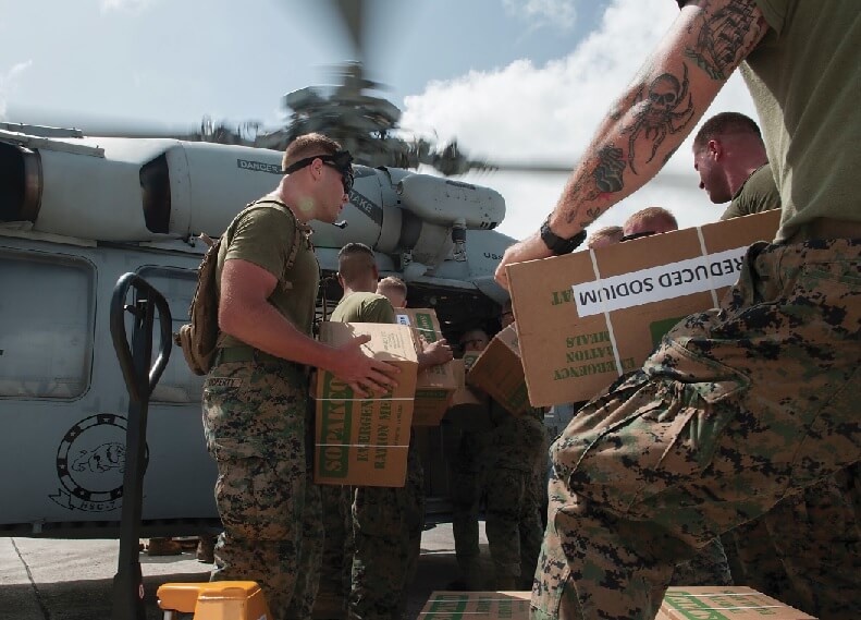 Sailors and Marines load food and water into an MH-60S Sea Hawk helicopter in support of relief efforts in the wake of Hurricane Irma in the U.S. Virgin Islands on Sept. 11. U.S. Navy MC2 Rawad Madanat Photo