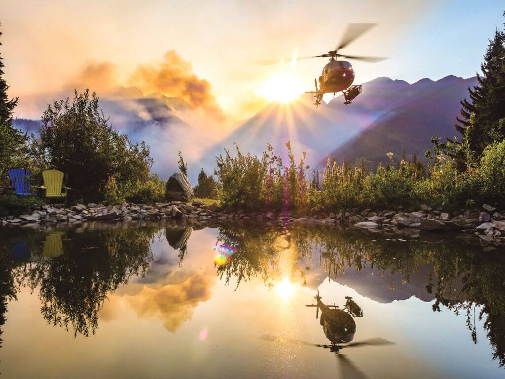 Maur Mere's grand-prize-winning photo of an Airbus AS350 AStar perfectly reflected in a still mountain pond as it takes off to begin firefighting operations in British Columbia. Maur Mere Photo
