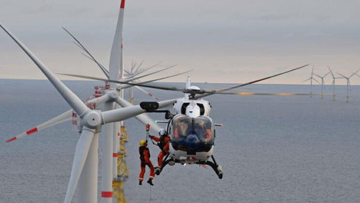 A Wiking Helicopter Service crewmember is hoisted down to a wind turbine from one of the company's Airbus H145s. According to Waypoint Leasing, Airbus leads the market in providing helicopters to the offshore wind turbine support industry. Wiking Helikopter Photo