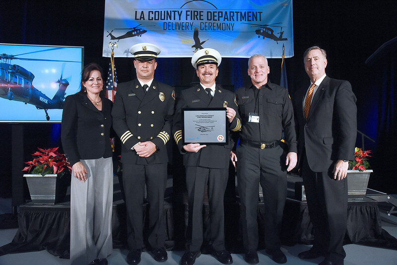 Jeanette Eaton, regional sales director for North America; Thomas Ewald, deputy chief of Los Angeles Fire Department's Air and Wildland Division; Vince Pena, deputy chief at Los Angeles County Fire Department; Dennis Blumenthal, chief of helicopter maintenance for the Los Angeles County Fire Department; and Bill Gostic, vice president of Sikorsky, present a plaque to the Fire Chiefs commemorating the delivery of the first S-70i Black Hawks in the U.S. and continuing the Firehawk legacy with the Los Angeles County Fire Department. Lockheed Martin Photo