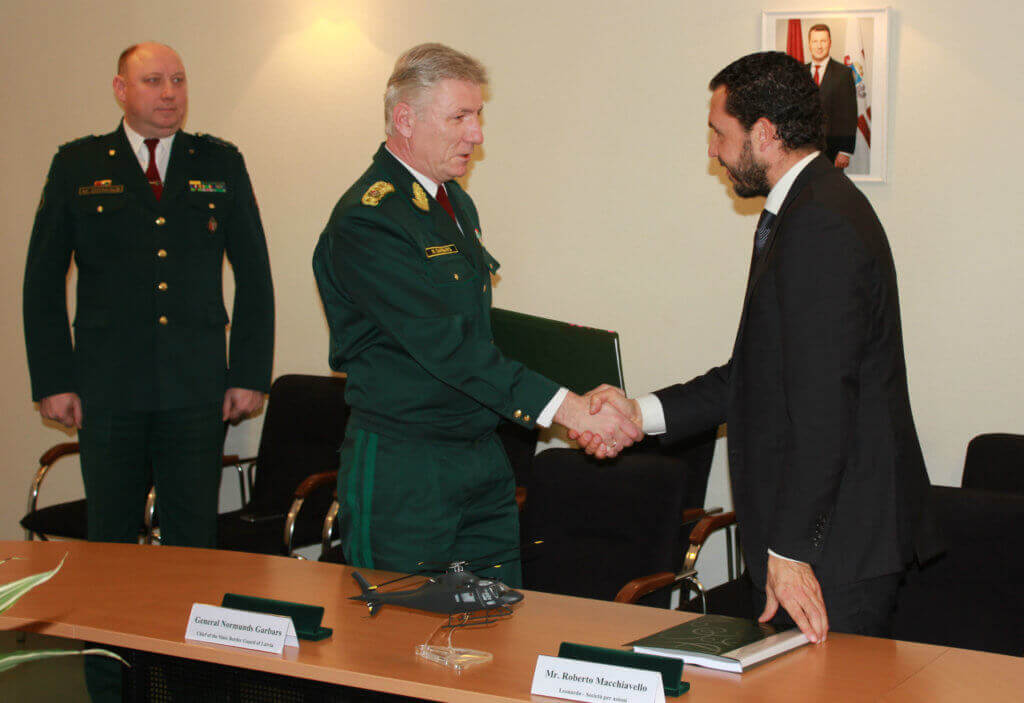 Gen. Normunds Garbars, chief of the State Border Guard of Latvia, shakes hands with Roberto Macchiavello from Leonardo Corporation in recognition of the new AW119Kx contract. Leonardo Photo 