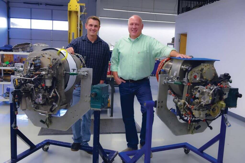ITS owner Darryl Christensen (right) stands with his son Brad Christensen, ITS's quality manager, behind the LTS101 and HTS900 engines. Mike Reyno Photo