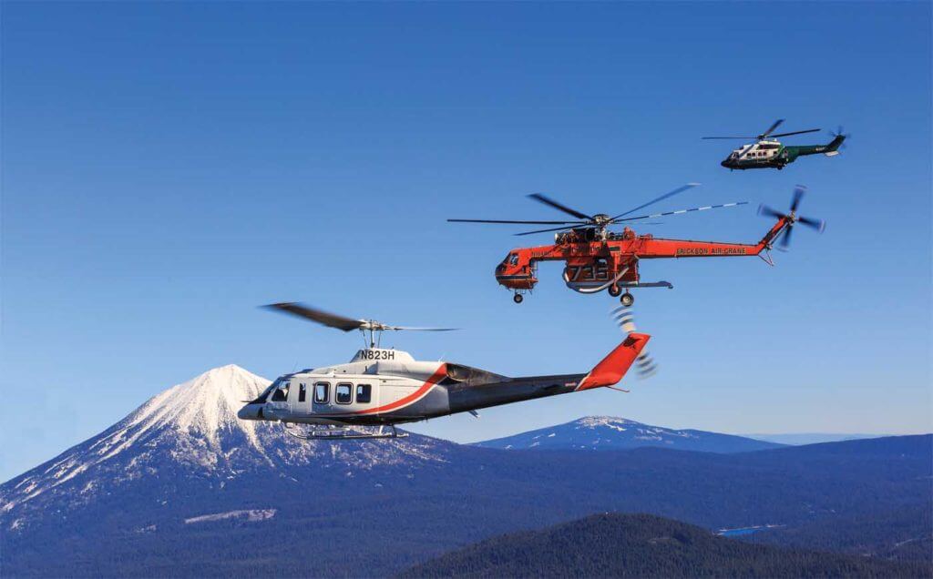 A unique company with a unique fleet. An Erickson S-64E Aircrane (center) is flanked by the two other mainstays of Erickson Inc.'s fleet - a Bell 214ST (foreground) and an Airbus AS332L1 Super Puma (background). Heath Moffatt Photo