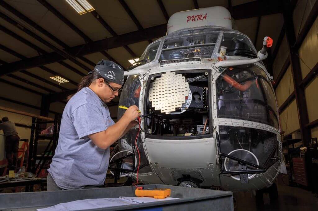 Avionics/airframe maintenance engineer Mingan Kijika conducts a wiring test on an Airbus AS330 Puma. Heath Moffatt Photo
