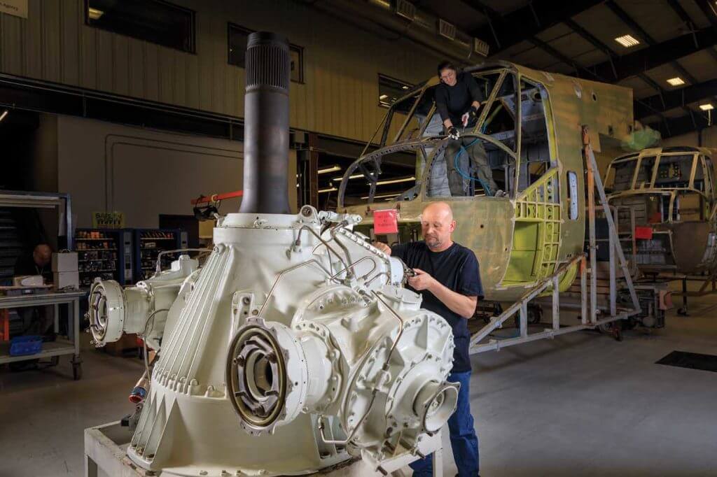 Tory Grussling checks fittings on the main rotor gear box and mast assembly of an S-64. Heath Moffatt Photo 