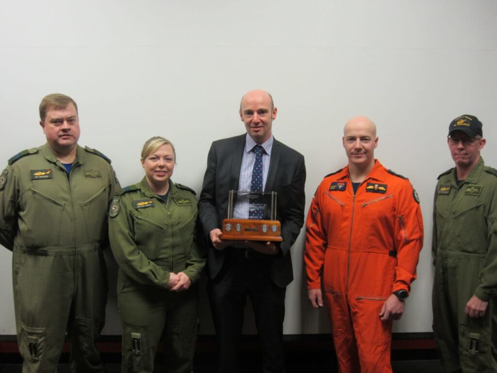 From left, Maj. Jim Pinhorn, Capt. Nicole Lively, Mark Fair of Leonardo Helicopters MW Ltd., MCpl Anthony Bullen, and MCpl Sean O'Callaghan stand with the Cormorant Trophy. Missing from the photo is Sgt. Damien Robison. Canadian Armed Forces Photo