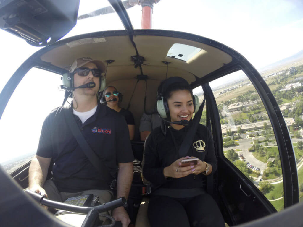 A pilot and passengers during a tour in a Robinson helicopter