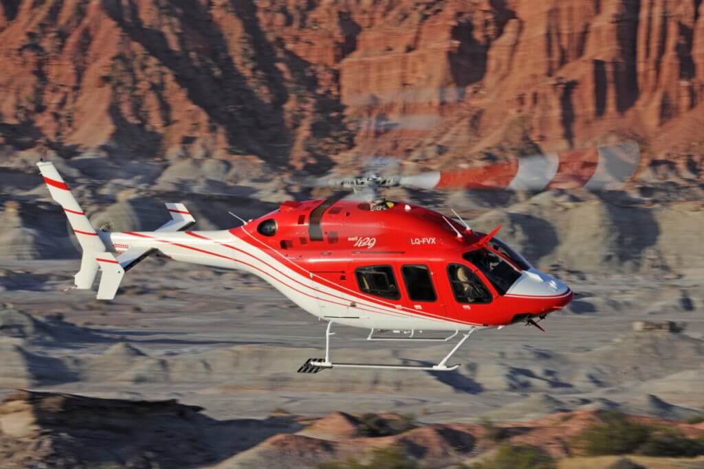 A red-and-white Bell 429 helicopter in flight