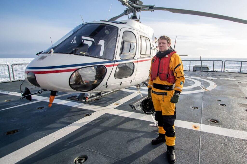 Airlift pilot Tom Andreas Østrem stands with the Airbus AS350 used for the mission, on board the Norwegian Coast Guard icebreaker KV Svalbard. Marius Villanger Photo