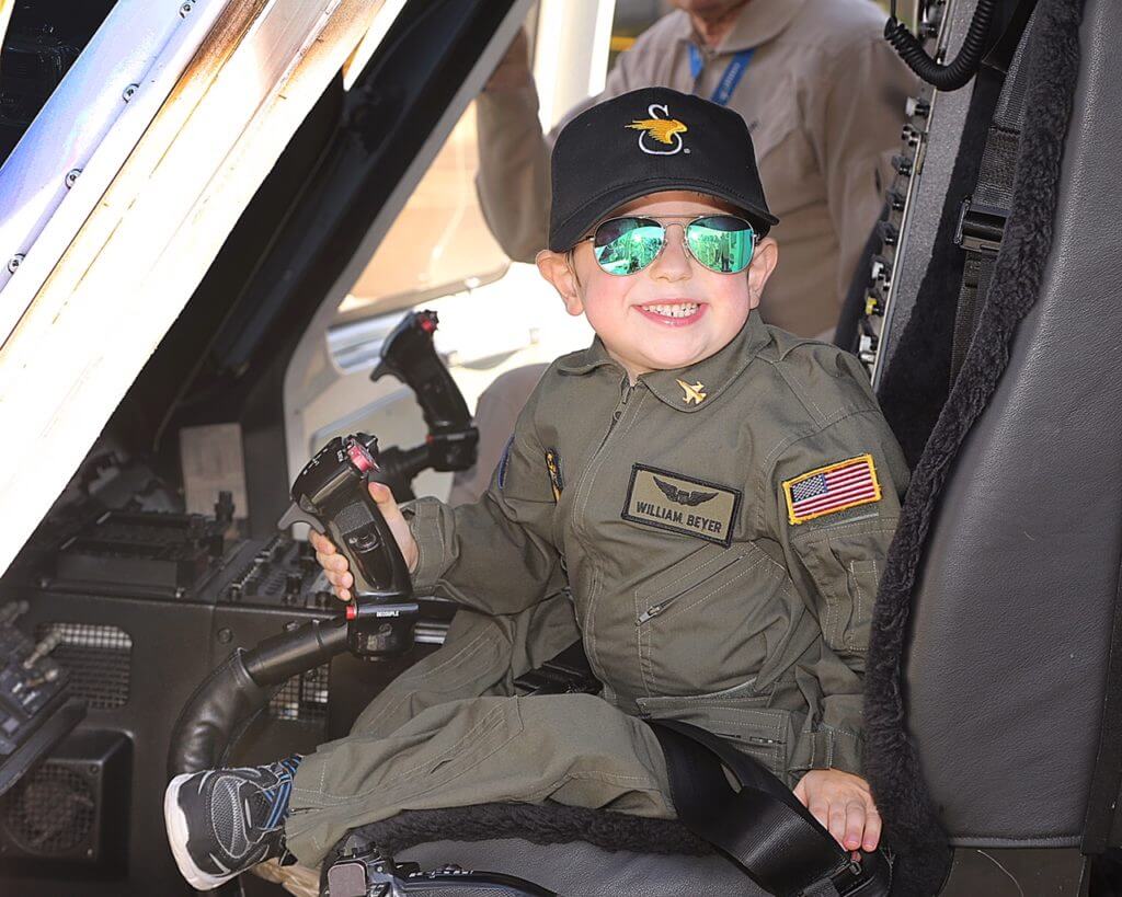 Six-year-old William Beyer sits in the cockpit of a Sikorsky S-76 helicopter.