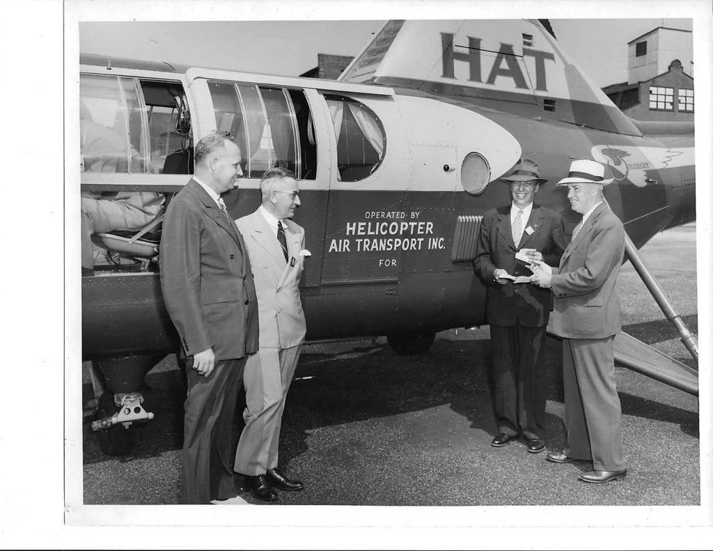 Sikorsky officials (on the left) deliver the first S-51 to HAT executives (on the right) in August 1946 at the manufacturer's plant in Bridgeport. Jeff Evans Collection Photo