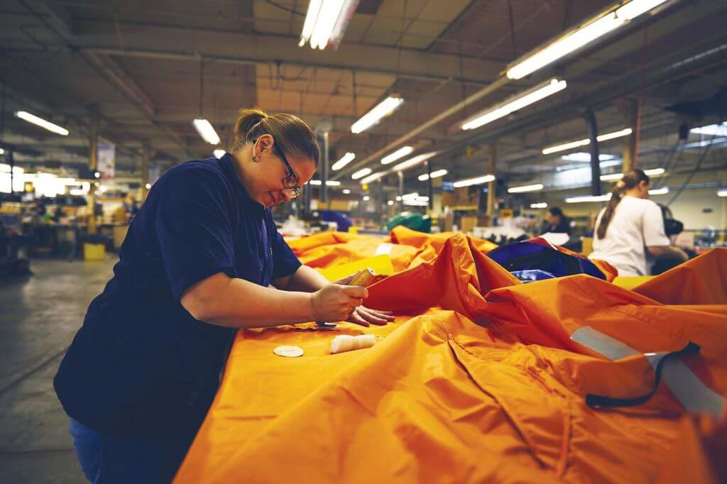 A staff member is shown constructing Switlik's unique convertible canopy for life rafts. The canopy allows raft users to keep the elements out in extreme weather conditions. Switlik Photo