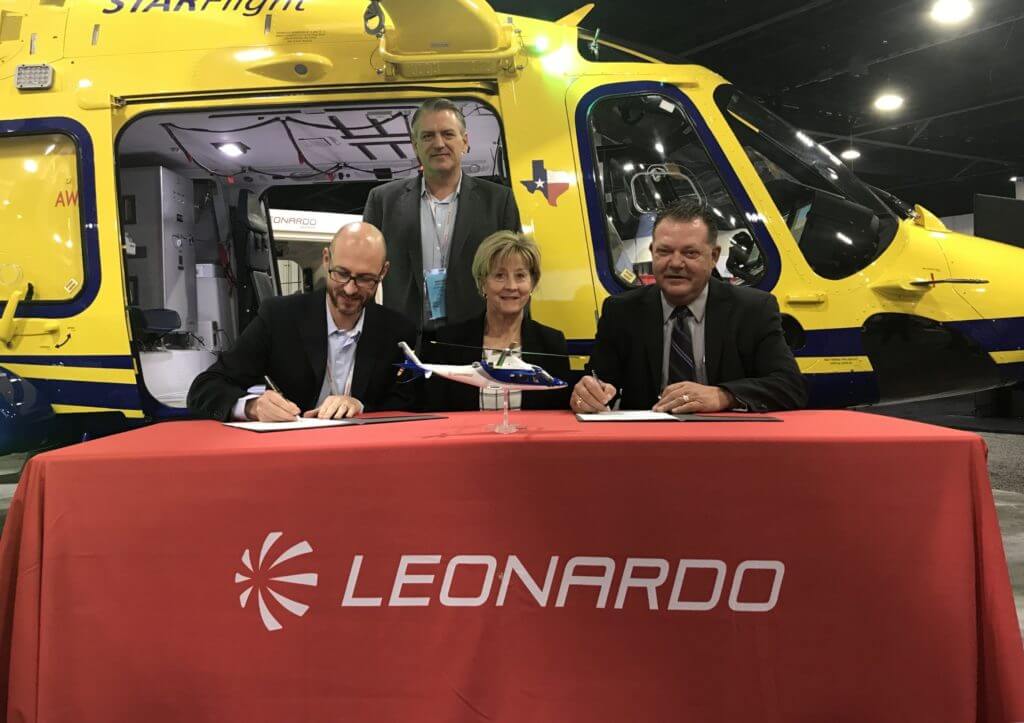Officials from Leonardo and Intermountain Life Flight sign a contract for the new aircraft at AMTC 2019. Leonardo Photo